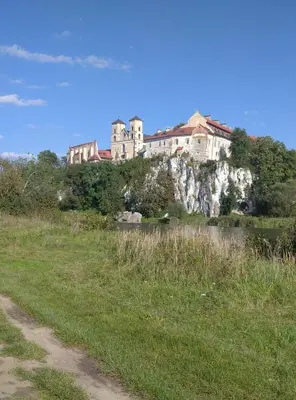 a castle sitting on top of a hill next to a field at Green corner in Kraków