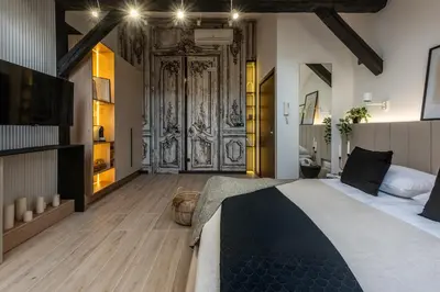 a bedroom with a bed and a table and chairs at Skyline by MB Apartments in Kraków