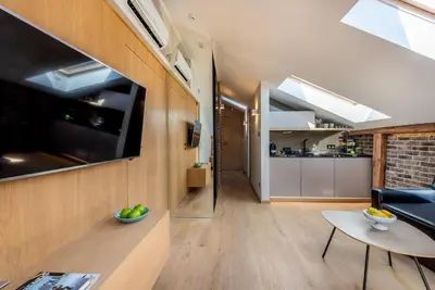 a living room with a couch and a table at Skyline by MB Apartments in Kraków