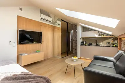 a room with a bed and a couch and a table at Skyline by MB Apartments in Kraków