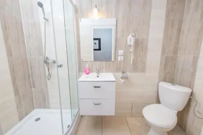 a bed in a room with a large window at Queen Apartments in Kraków