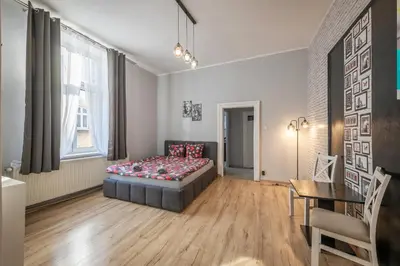 a living room with a couch and a bed at Queen Apartments in Kraków