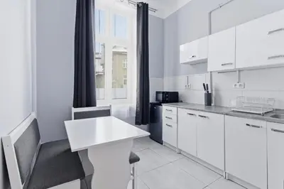 a bathroom with a toilet and a sink and a mirror at Queen Apartments in Kraków
