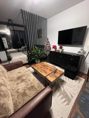 a living room with a couch and a coffee table at Rydlowka 21 apartament in Kraków