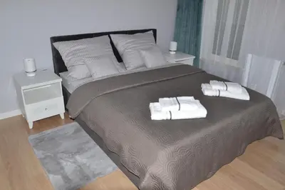 a bedroom with a large bed with towels on it at Apartament Krakusek Kraków in Kraków