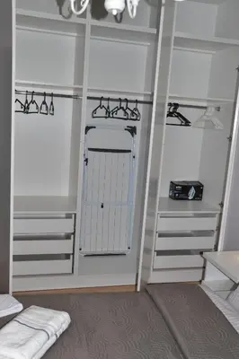a room with a white closet with a white gate at Apartament Krakusek Kraków in Kraków