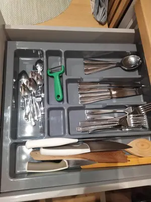 a tray of utensils in a drawer with utensils at Apartament Krakusek Kraków in Kraków