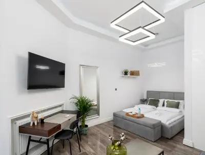 a living room with a bed and a table at Malila Premium Apartments Cracow Centre Starowiślna 43 in Kraków