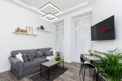 a living room with a couch and a table at Malila Premium Apartments Cracow Centre Starowiślna 43 in Kraków