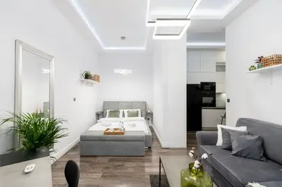 a living room with a bed and a couch at Malila Premium Apartments Cracow Centre Starowiślna 43 in Kraków