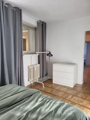 a bedroom with a bed and a dresser and a mirror at Mieszkanie na Starym Podgórzu. in Kraków