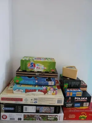 a stack of books stacked on top of each other at Mieszkanie na Starym Podgórzu. in Kraków