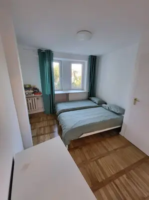 a small room with a bed and a window at Mieszkanie na Starym Podgórzu. in Kraków