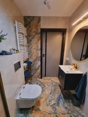 a bathroom with a toilet and a sink at Apartament Jacuzzi in Kraków