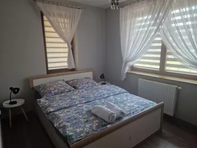 a bedroom with a bed with two towels on it at Dom w górach in Lipnik