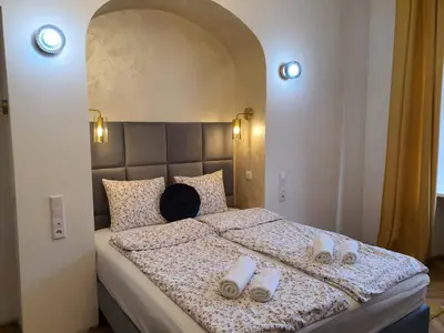a bedroom with a large bed with a headboard at Old Town OK Apartments in Kraków