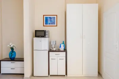 a kitchen with a white refrigerator and a microwave at Old Town OK Apartments in Kraków