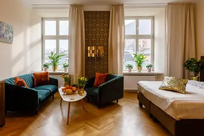 a hotel room with a bed and a couch and a table at Old Town OK Apartments in Kraków