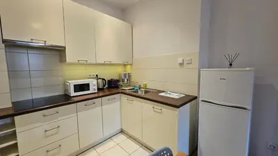 a bathroom with a white sink and a toilet at Old Town OK Apartments in Kraków