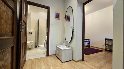 a kitchen with white cabinets and a white refrigerator at Old Town OK Apartments in Kraków
