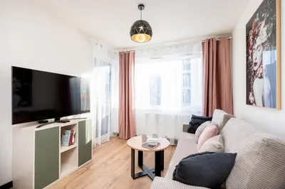 a living room with a couch and a table at Dabie Park Residence in Kraków