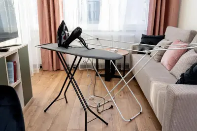 a table with a laptop on it in a living room at Dabie Park Residence in Kraków