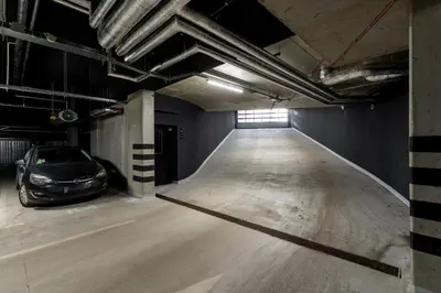 a parking garage with a car parked in it at Dabie Park Residence in Kraków