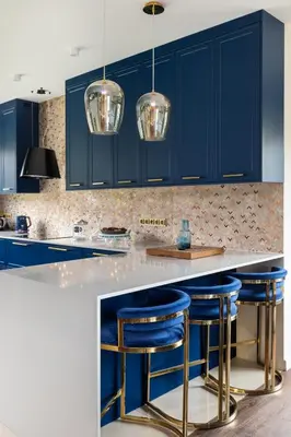 a kitchen with blue cabinets and blue bar stools at Granatowy Dom in Stary Wiśnicz