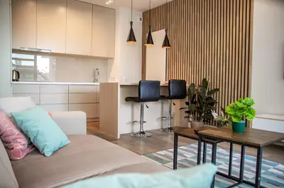 a living room with a couch and a table at InPoint Wawel View Apartments- Free Underground Parking in Kraków