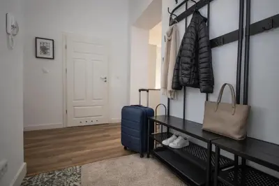 a room with a table with a blue suitcase at InPoint Wielopole 32 Boutique Apartments Old Town&Kazimierz District Self Check-in in Kraków