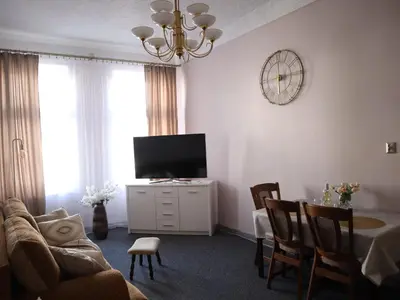 a living room with a television and a table with chairs at 555 Flat - 55 m² mieszkanie, 5 min - Dworzec Główny in Kraków