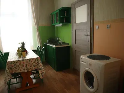 a kitchen with a table and a washing machine at 555 Flat - 55 m² mieszkanie, 5 min - Dworzec Główny in Kraków