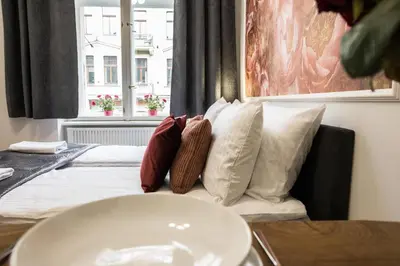a bedroom with a bed with pillows on it at CracWoW K8 Apartments in Kraków