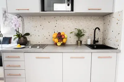 a kitchen with a bowl of fruit on a counter at CracWoW K8 Apartments in Kraków