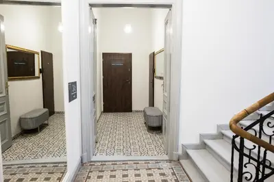 a hallway with stairs leading to a door at CracWoW K8 Apartments in Kraków