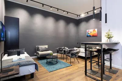 a bedroom with a bed and a table and chairs at Rainbow Apartments Old Town in Kraków