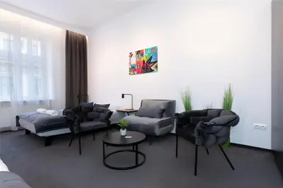 a living room with couches and a table at Rainbow Apartments Old Town in Kraków