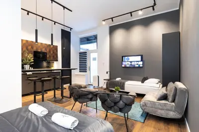 a living room with a couch and a table at Rainbow Apartments Old Town in Kraków
