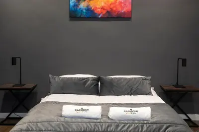 a bedroom with a bed with two towels on it at Rainbow Apartments Old Town in Kraków