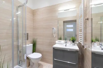 a bathroom with a toilet and a sink and a shower at Rainbow Apartments Old Town in Kraków