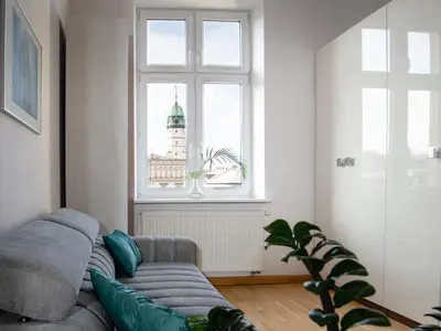 a living room with a couch and a window at Amazing apartament in the heart of Kazimierz in Kraków