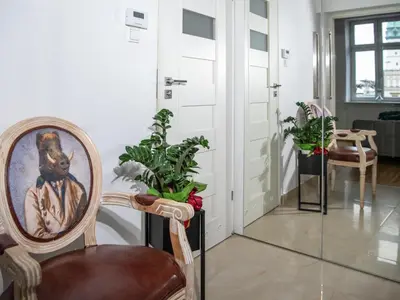 a room with a chair and some plants at Amazing apartament in the heart of Kazimierz in Kraków