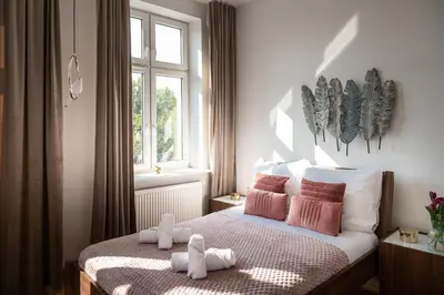 a bedroom with a bed with two stuffed animals on it at Amazing apartament in the heart of Kazimierz in Kraków