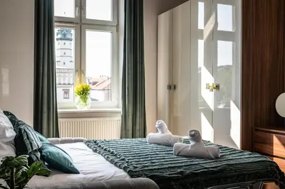 a bedroom with two dolls on a bed with a window at Amazing apartament in the heart of Kazimierz in Kraków