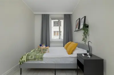 a small bedroom with a bed and a window at Home Office - 2-Bedroom Apartment Corpo-Stay in Kraków by Noclegi Renters in Kraków