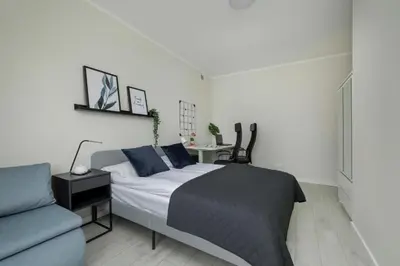 a bedroom with a bed and a table and a couch at Home Office - 2-Bedroom Apartment Corpo-Stay in Kraków by Noclegi Renters in Kraków