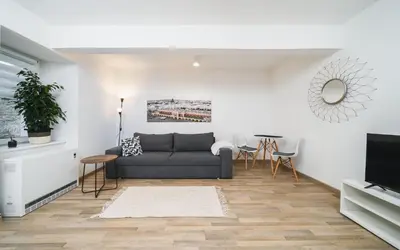 a living room with a couch and a table at Apart-Studio Close Wawel Castle in Kraków