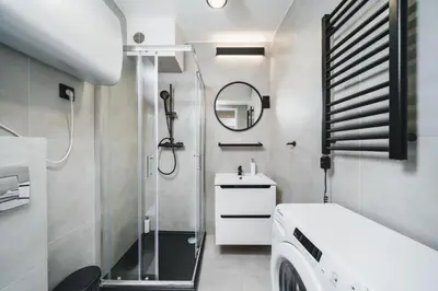 a bathroom with a shower and a sink and a mirror at Apart-Studio Close Wawel Castle in Kraków
