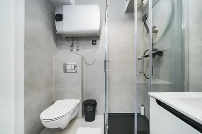 a small bathroom with a toilet and a shower at Apart-Studio Close Wawel Castle in Kraków