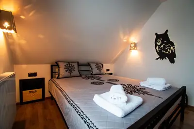 a bedroom with a bed with towels on it at Cyrhel Apartments in Zawoja